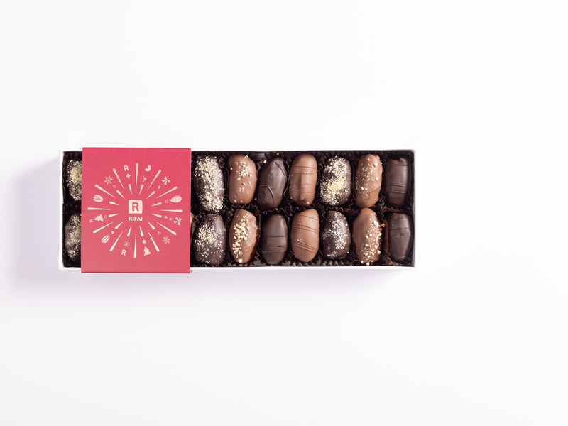 Luxury assortment of stuffed dates with ashta, hazelnut, nut praline, and mastique fillings, coated in milk and dark chocolate.